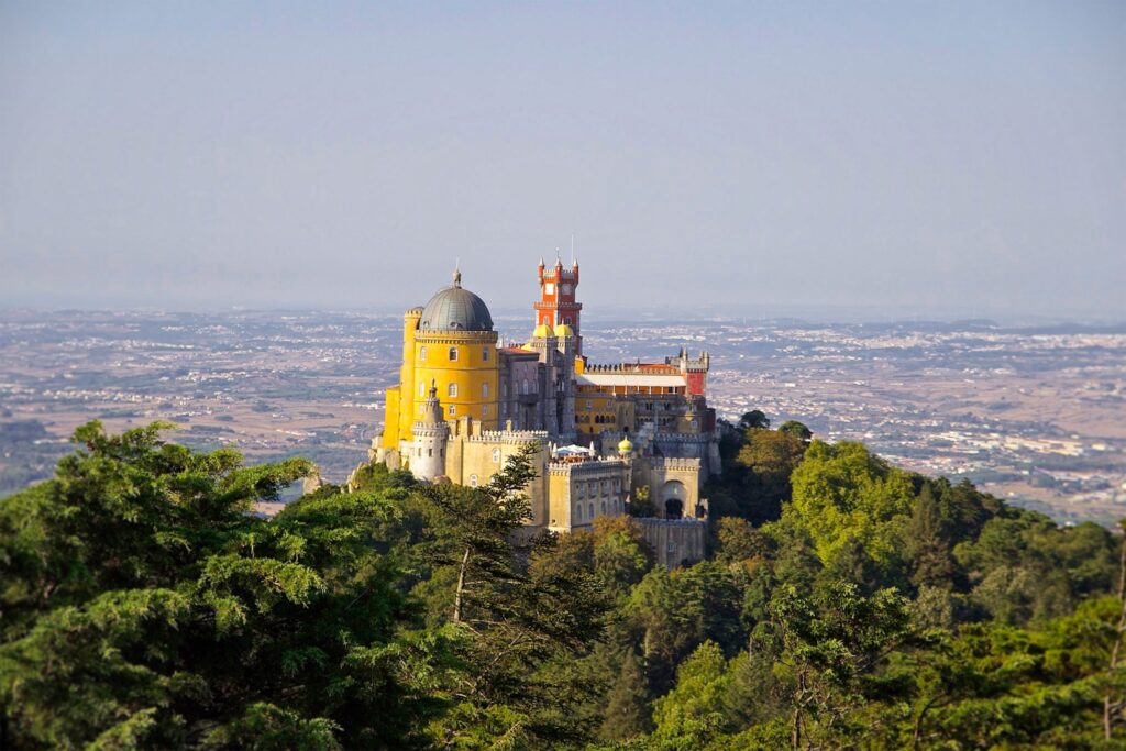 Colourful Pena Palace in Sintra surrounded by green forest