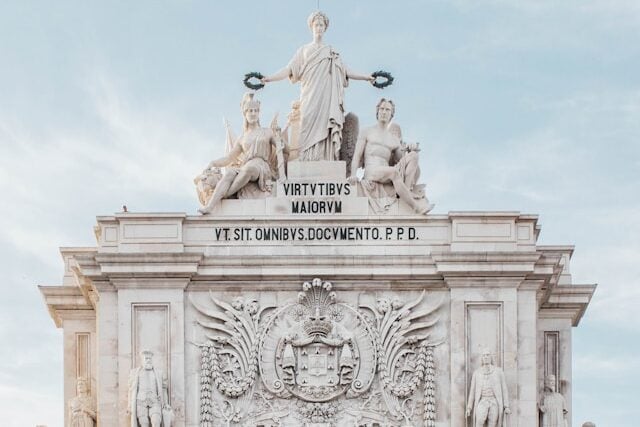 Front view of the Rua Augusta Arch Lisbon featuring the Glory, Genius, and Valour sculpture on top of the triumphal arch