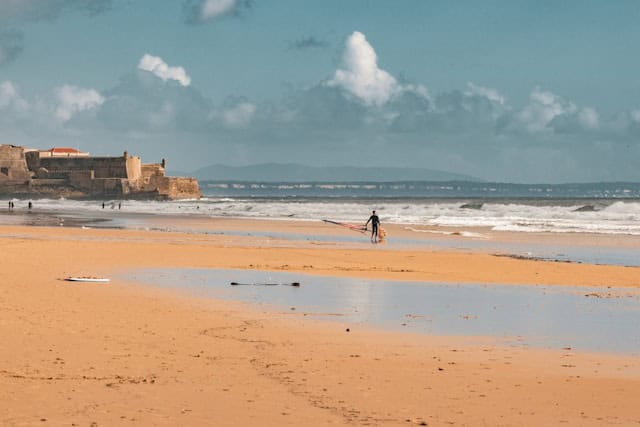 Kitesurfer at Praia de Carcavelos Lisbon with the São Julião da Barra fort in the background