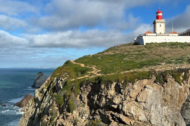 A red lighthouse on top of Cabo Espichel in Sesimbra