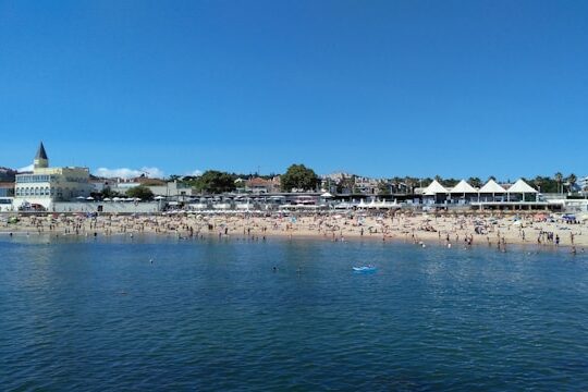 People enjoying the sun and swimming at Praia do Tamariz in Estoril Portugal