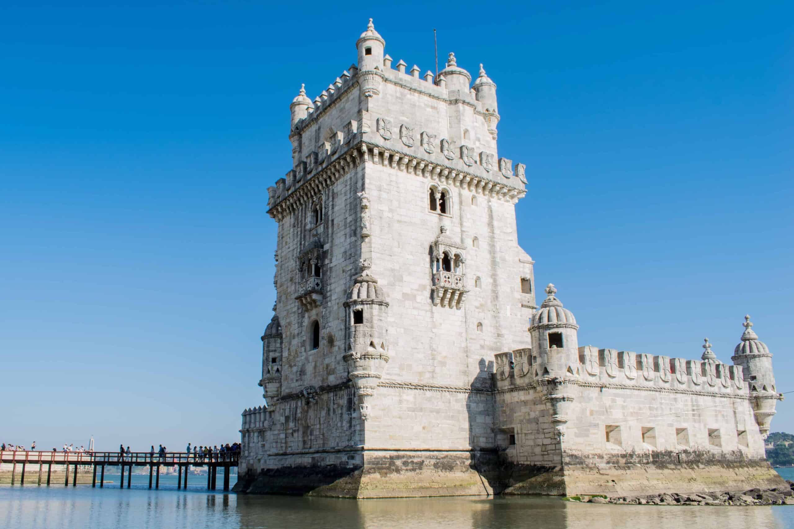 Belém Tower on the riverbank in Lisbon under a clear blue sky