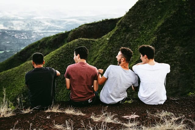 Four friends laughing at the top of a hill during a Lisbon stag do weekend