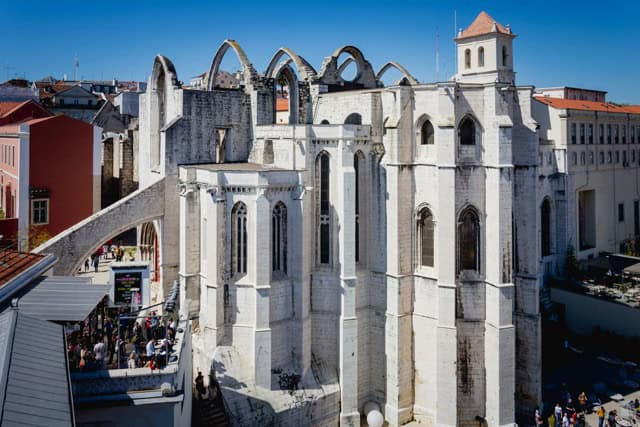 Exterior of the Carmo Convent in Lisbon, showing the Gothic arches and facade of the ruined church